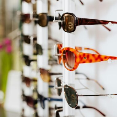 A vibrant assortment of fashionable sunglasses displayed on a store rack, ready for a trendy sale.